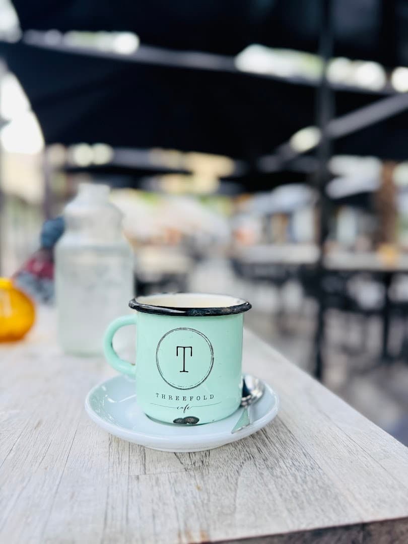 Threefold Cafe coffee cup in Coral Gables