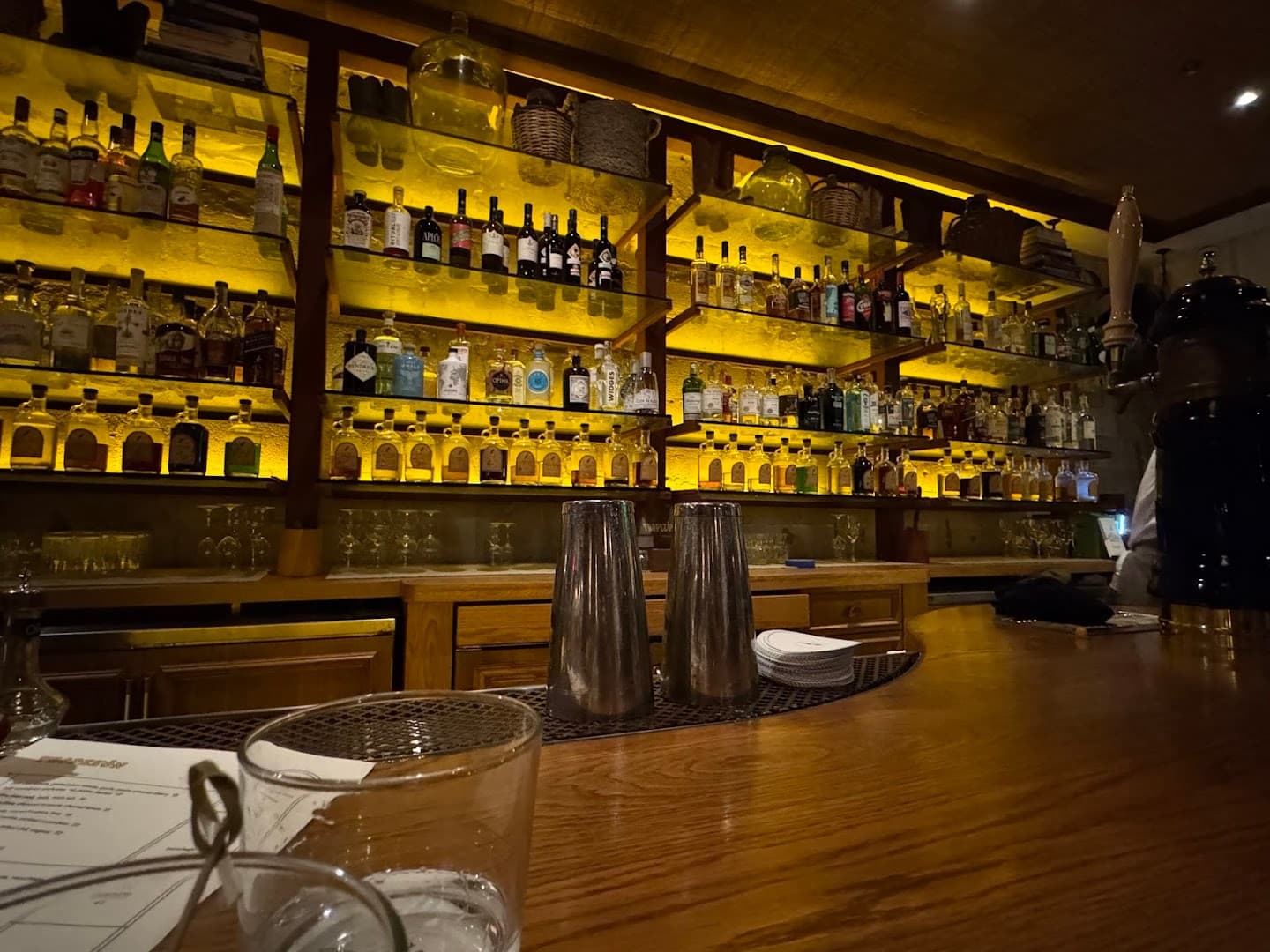 Bar area at Tropezón Miami with illuminated shelves