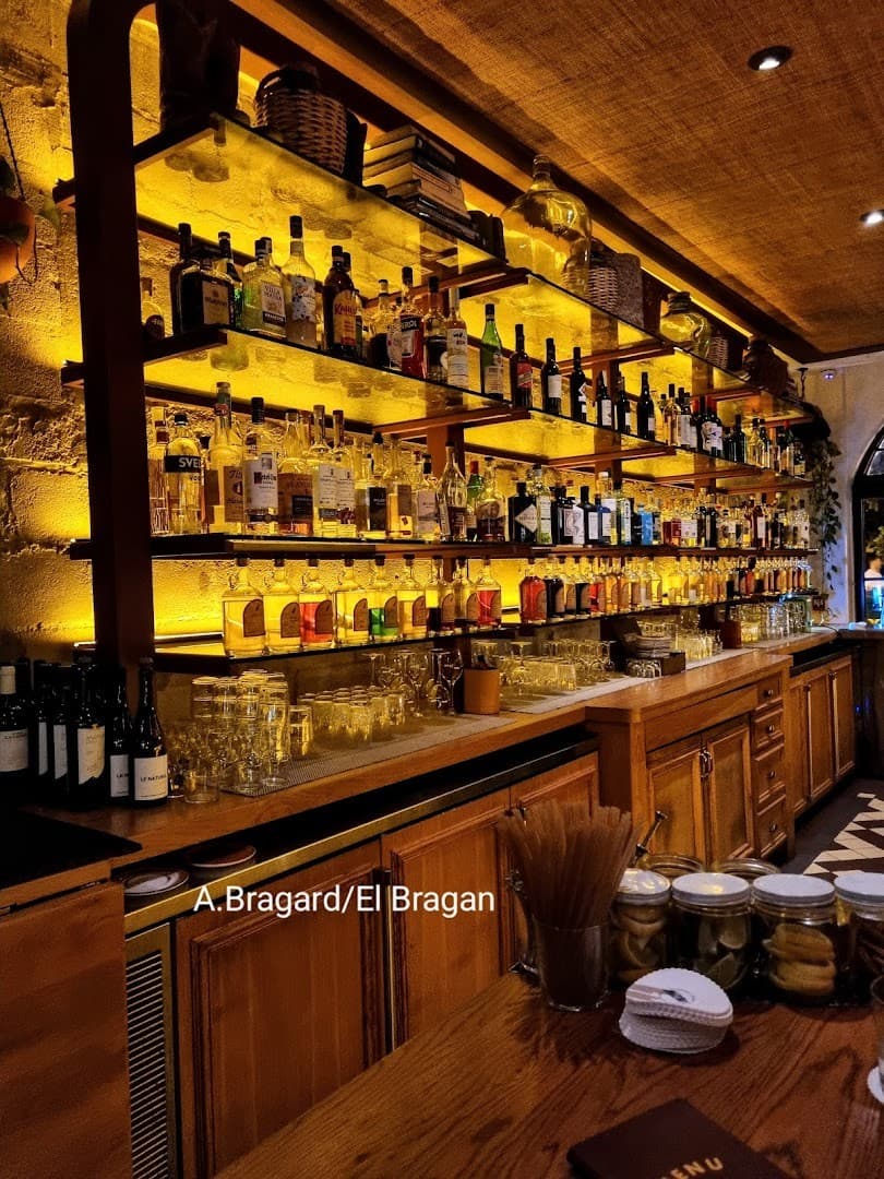 Bar area at Tropezón Miami with shelves of spirits