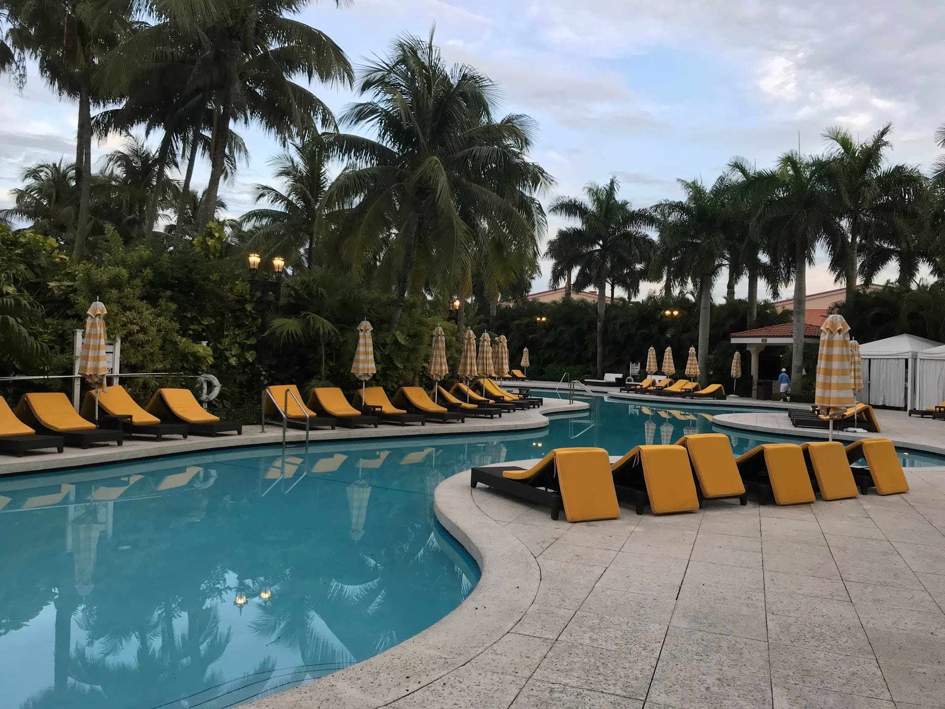 Trump National Doral Miami pool area with lounge chairs and palm trees